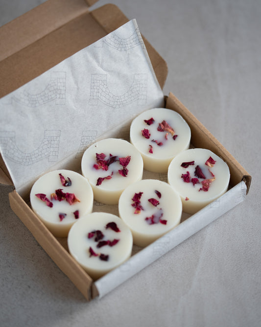 An open box of Howebridge Candles botanical soy wax melt. Sprinkled with dried rose petals, there's 6 in a box.