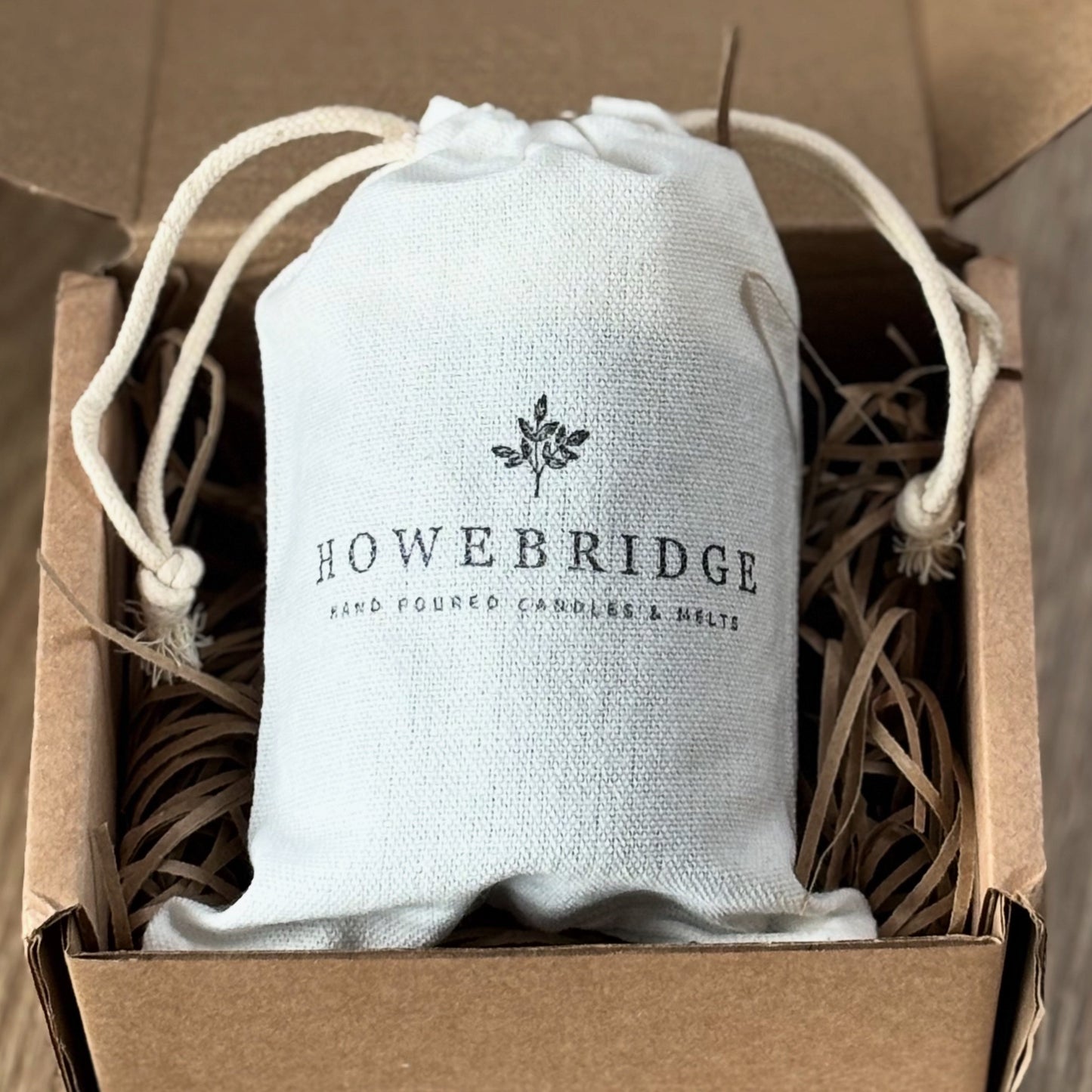 Cotton drawstring bag with 'Howebridge' branding. Recyclable and reusable for our sustainable candles.