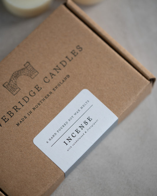 Howebridge Candles natural soy wax melts kraft box stamped with their logo and sealed with a scent descriptive label. The scent is called Incense with frangipani and sandalwood.