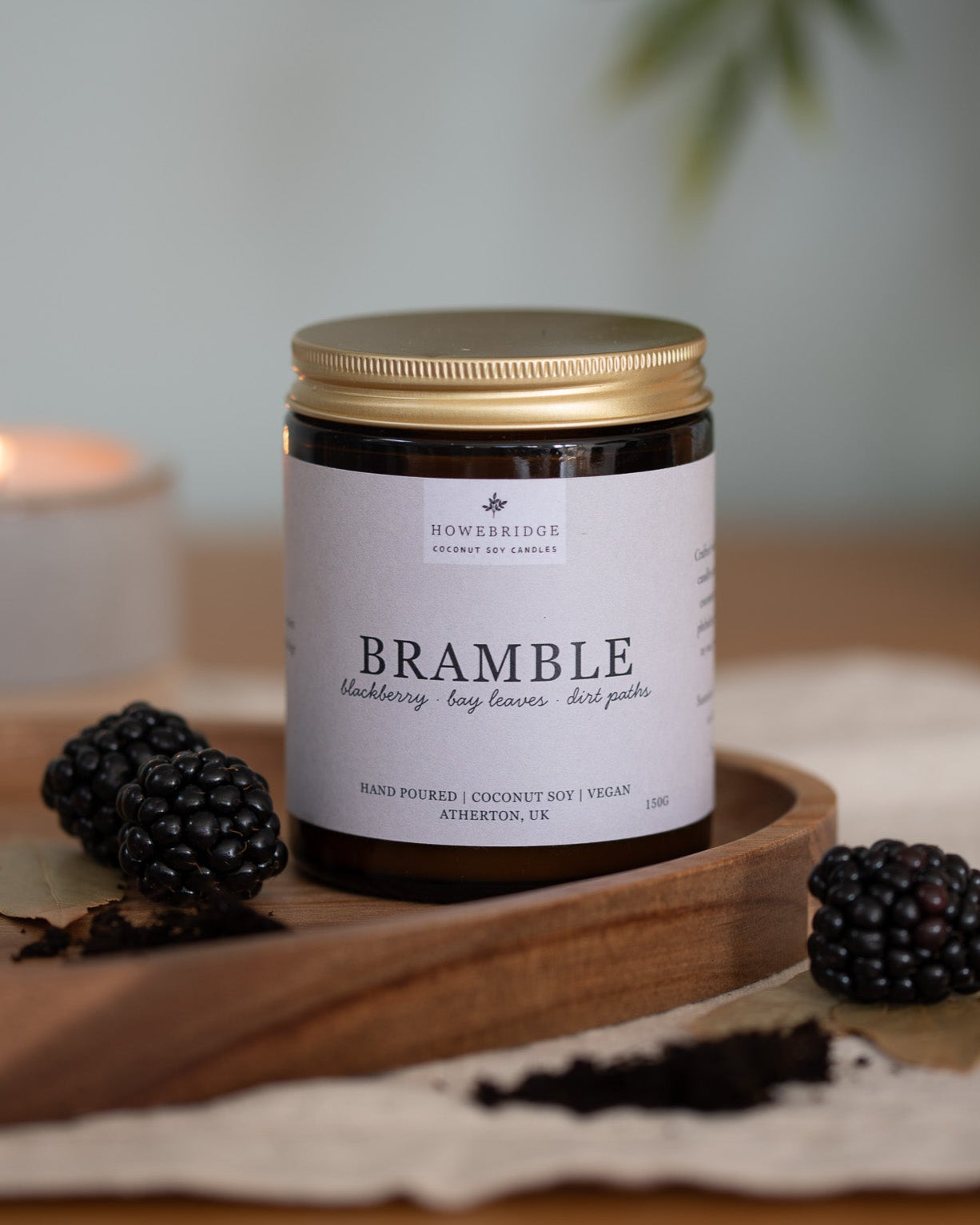 Bramble coconut soy wax candle. Scent: Blackberries, bay leaves and dirt paths. Hand poured in a glass amber jar with a natural beige label. The scent evokes the smell of being in the forest and blackberry picking in the late summer evening.