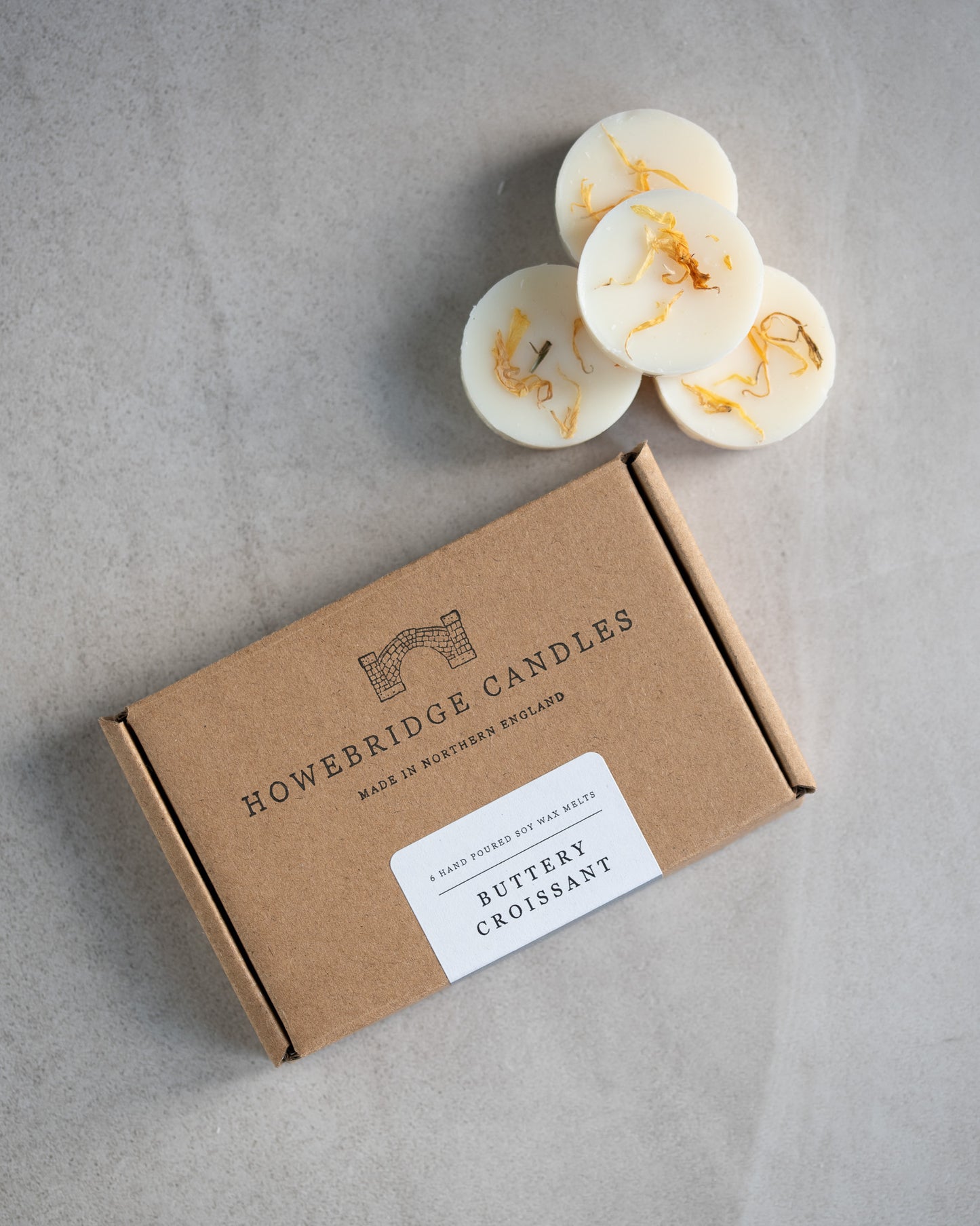 Howebridge candles soy wax melt box. Featuring logo and scented label and round soy wax melts sprinkled with dried botanicals.