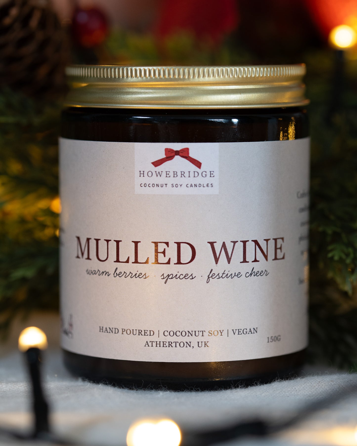 A natural wax candle in a amber jar and gold lid. Wrapped in a festive label with a red bow. The scent is mulled wine with notes of warm berries, spices and festive cheer. Hand poured, Vegan friendly and sustainably made.