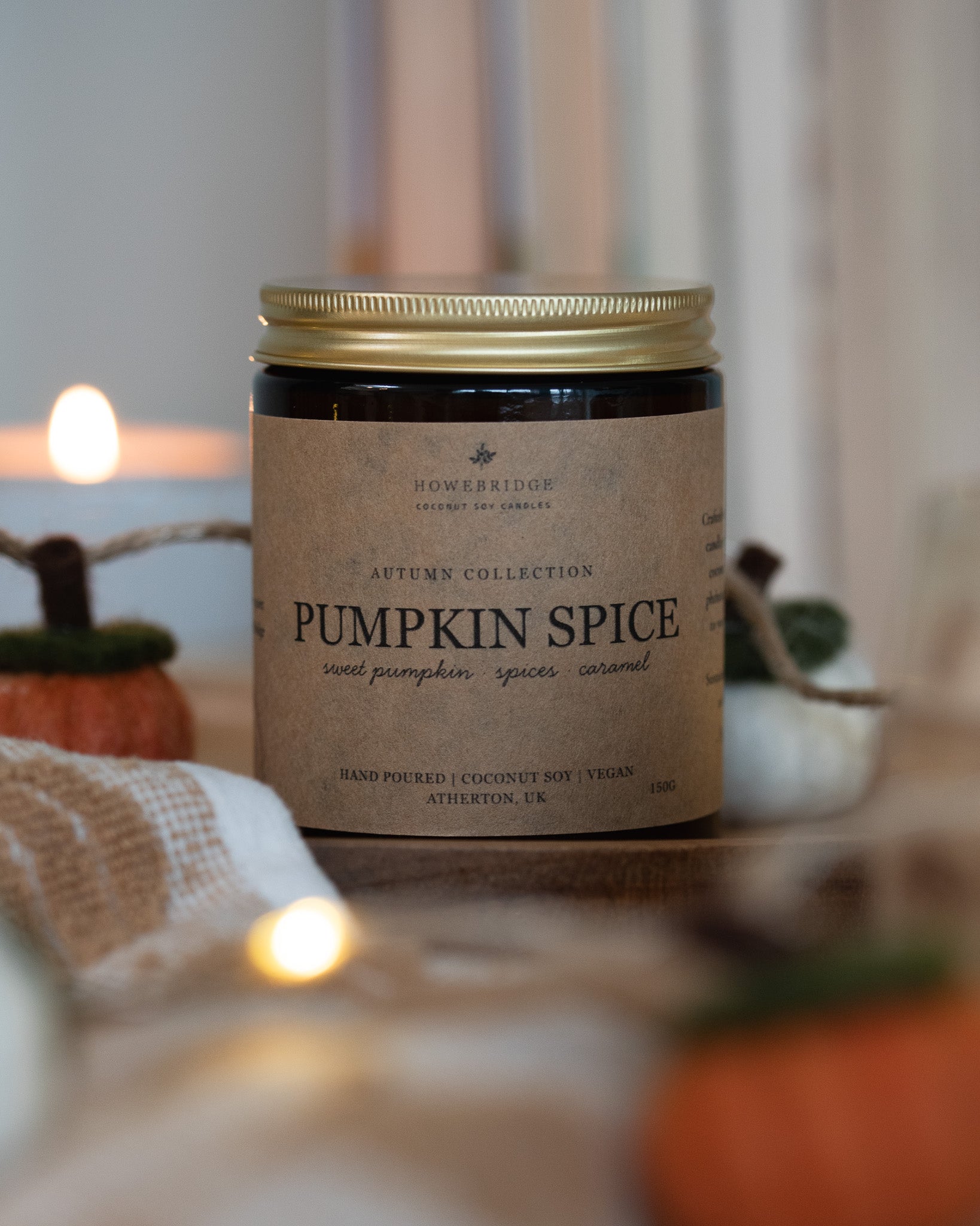 Pumpkin Spice scented coconut soy wax candle. Kraft brown candle label in a glass amber jar and gold lid. Cosy, autumnal and hand poured.