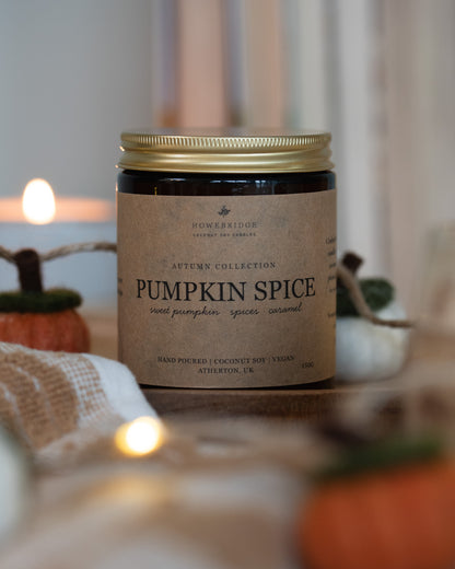 Pumpkin Spice scented coconut soy wax candle. Kraft brown candle label in a glass amber jar and gold lid. Cosy, autumnal and hand poured.