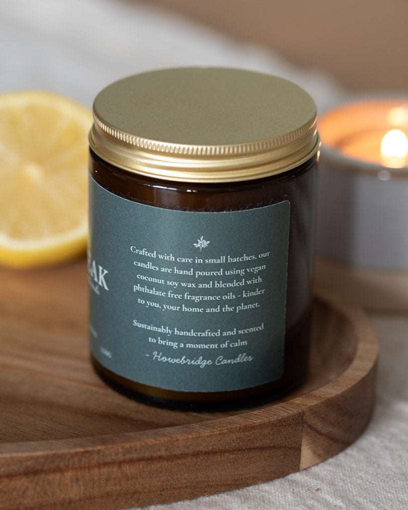 Lemon Peak Candle label featuring our botanical logo. Showing the side of the label which explains how our candles are hand poured with coconut soy wax and phthalate free oils. Scent: Lemongrass, ginger & patchouli. Sustainable luxury with a spa like, citrus scent.