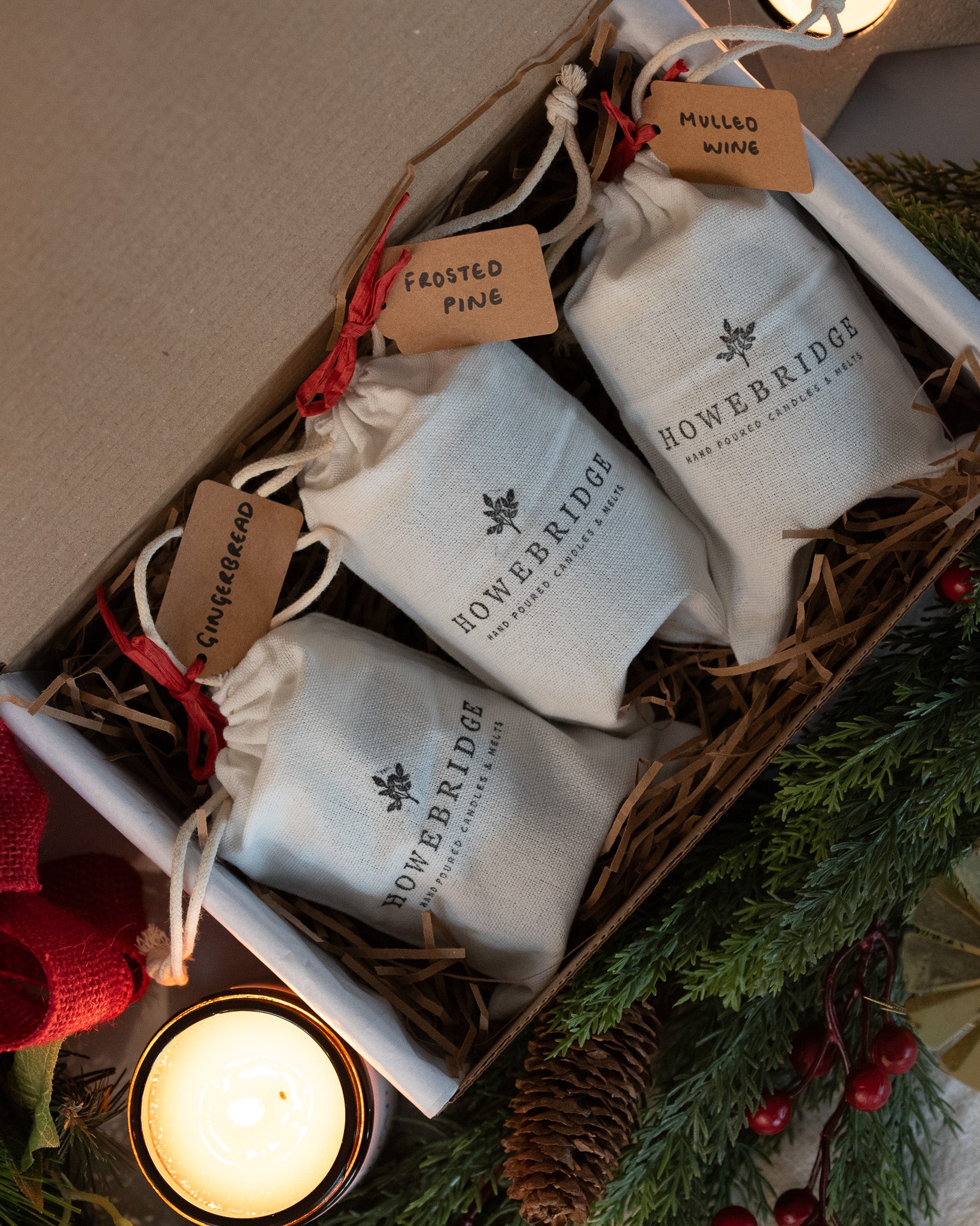 Howebridge trio of Christmas candles, gift wrapped in cotton drawstring bags and labeled. Scents of mulled wine, frosted pine and gingerbread. A lovely gift for a loved one this Christmas.