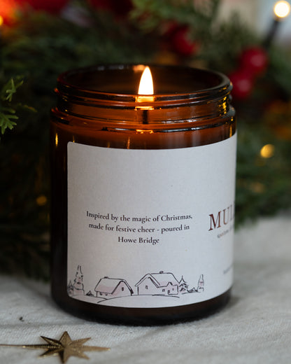 A wrap around candle label featuring a c
Christmas theme, fine line illustration of cottages, Christmas trees and snowmen. Inspired by the magic of Christmas, made for festive cheer - poured in Howe Bridge