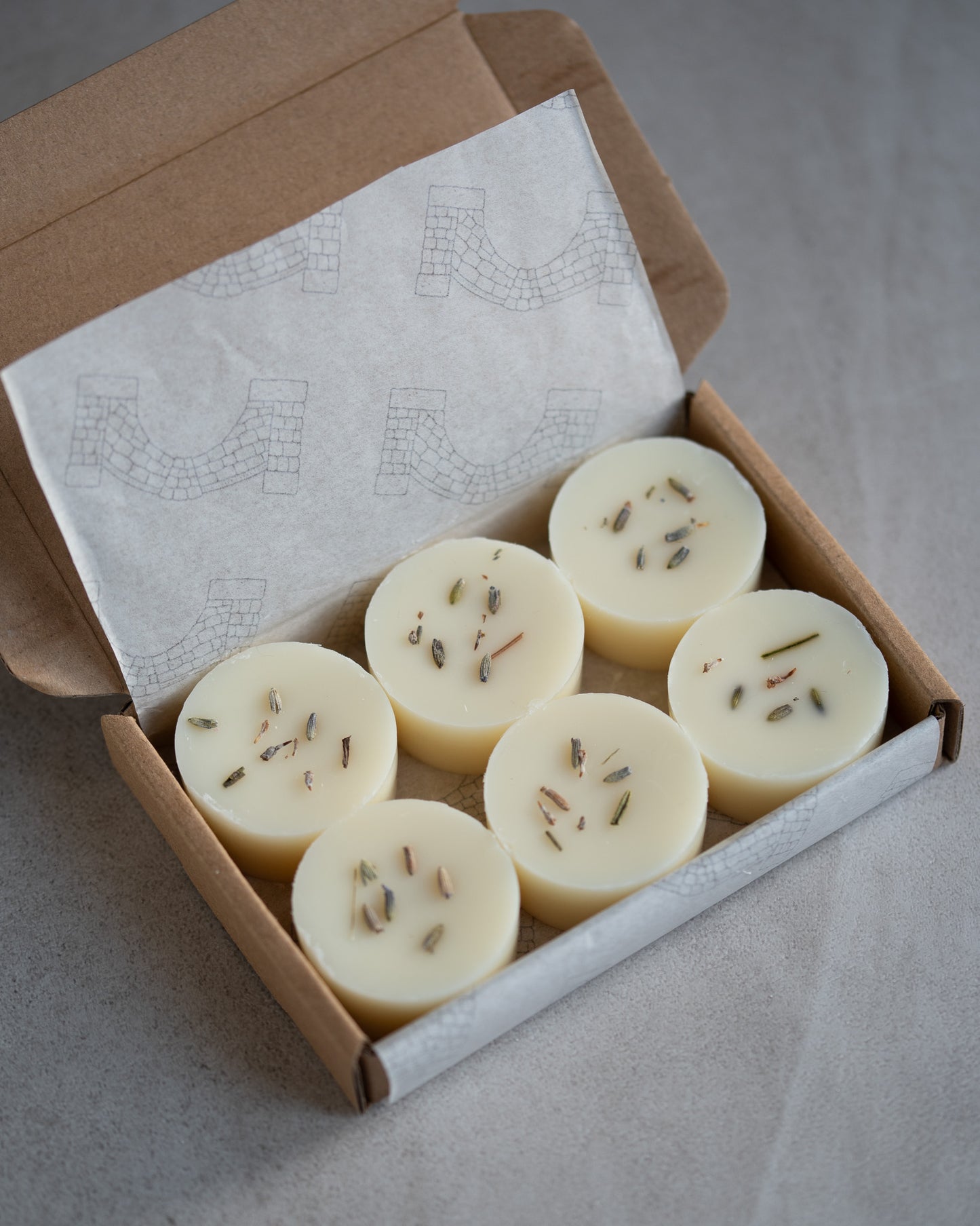 Howebridge Candles botanical soy wax melts. 6 round melt in a kraft box sprinkled with dried lavender.