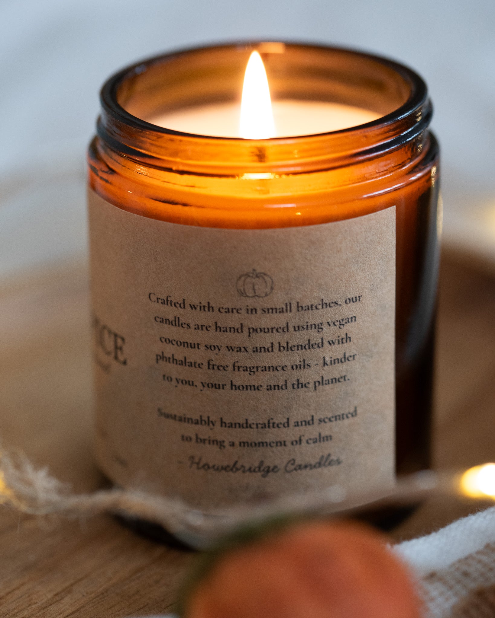 Pumpkin Spice coconut soy wax candle. Hand poured using coconut soy wax in small batches. Kraft brown label on a glass amber jar and gold lid.