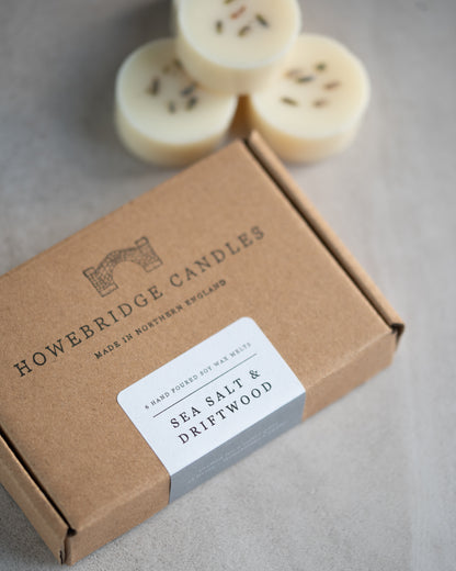 Howebridge Candles sea salt & driftwood wax melts inside a kraft box, stamped with their logo and sealed with a scent descriptive label.