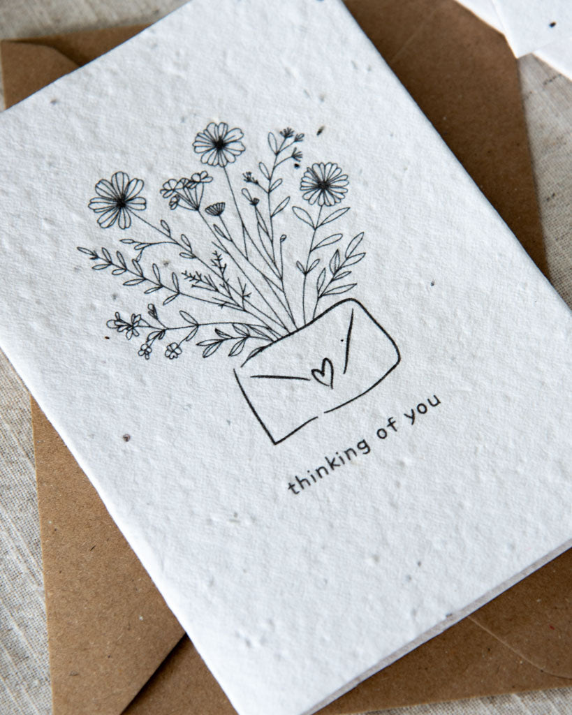 Wildflower plantable seed card with the message 'thinking of you' surrounded by botanicals. Printed on 100% cotton paper. Complete with C6 Kraft envelope. Can be personalised.