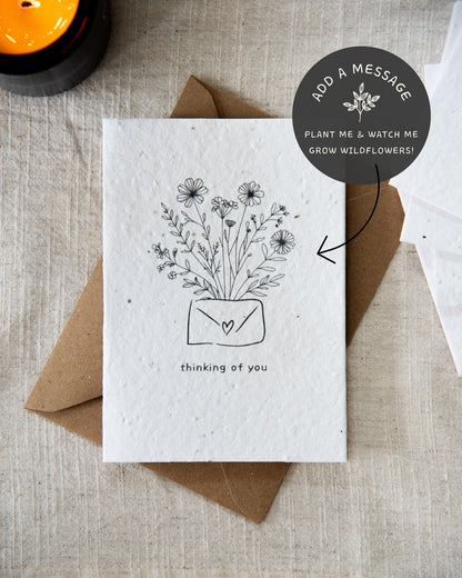 Wildflower plantable seed card with the message 'thinking of you' surrounded by botanicals. Printed on 100% cotton paper and complete with C6 Kraft envelope.