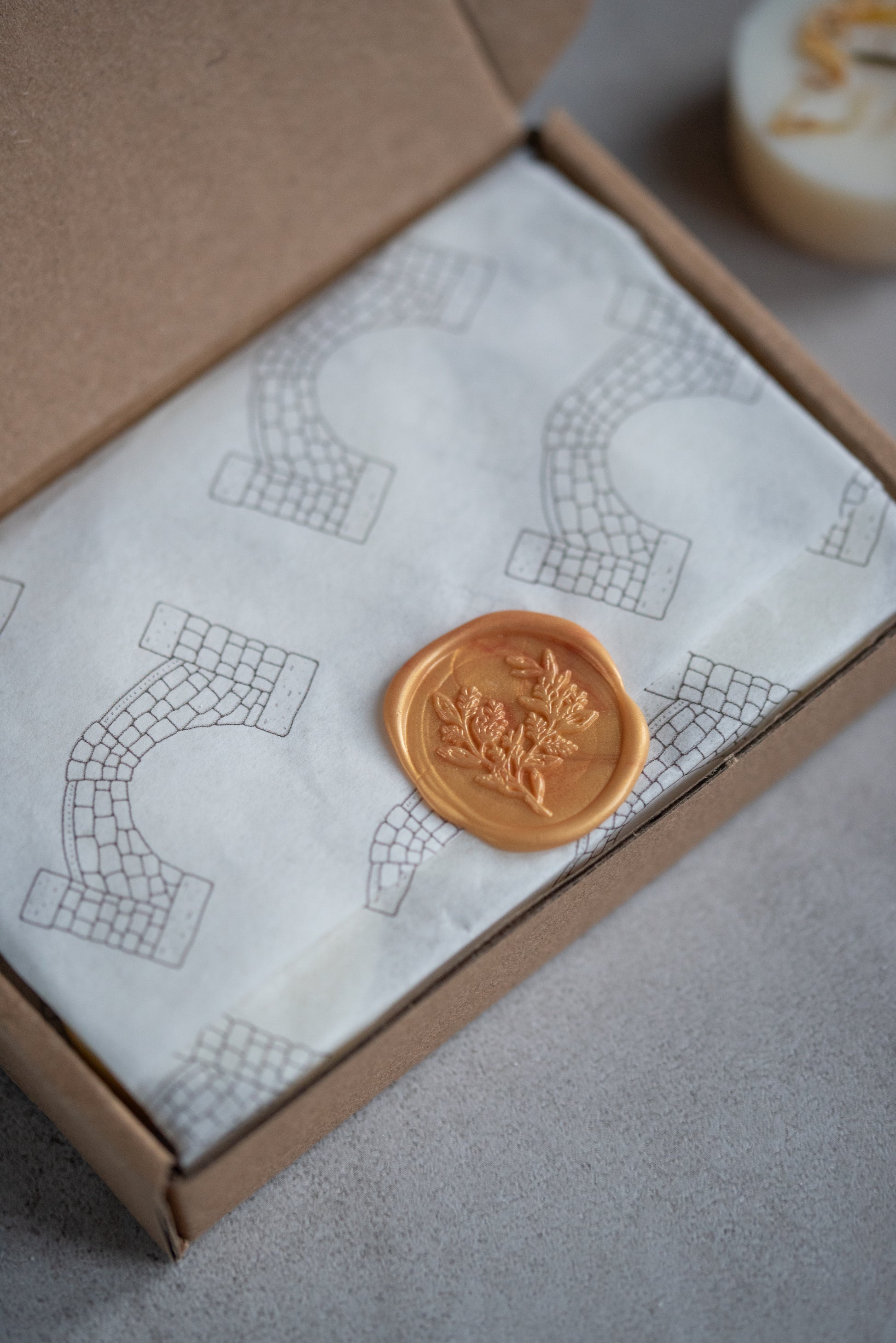 Kraft box filled with Howebridge Candles soy wax melts, beautifully wrapped in branded paper and sealed with a gold wax seal.
